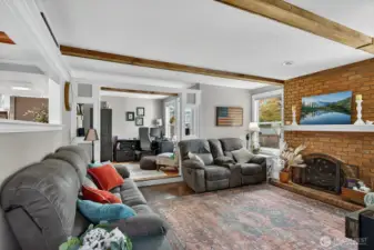 The living room is spacious and have a laminate style flooring.