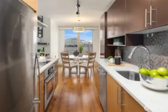 Sleek kitchen opens to dining.