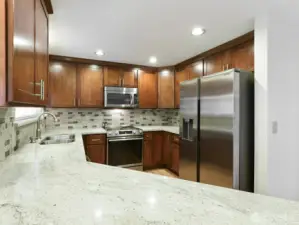 Granite counter tops. Tile backsplash. Newer Custom cabinets. Stainless appl