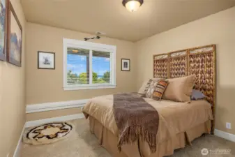 The second lower level bedroom with built-in display ledge beneath the window and the western water views.