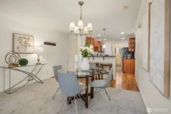 Open sightlines from the living and dining areas into the kitchen, with the separate utility room tucked just beyond