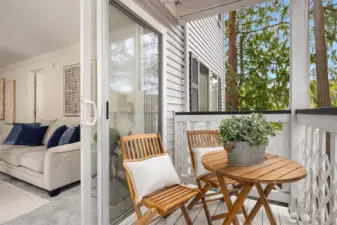 Cozy deck overlooking the peaceful wooded area behind the condo, offering a private and relaxing outdoor retreat