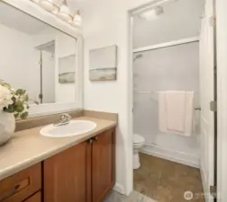 Primary bathroom featuring a spacious vanity with cherry cabinets and a separate walk-in shower
