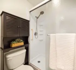 Another look at the primary bath, with added above-toilet storage