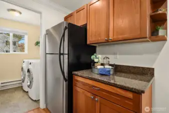 Another view of the kitchen with a peek into the utility/laundry room, featuring newer washer and dryer.