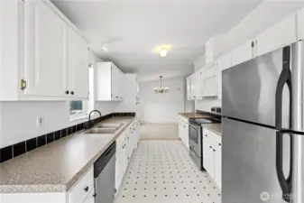 Freshened up kitchen has stainless appliance and good counter workspaces.