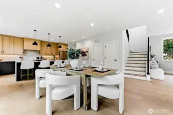 The dining room takes in glimpses of the generous kitchen area
