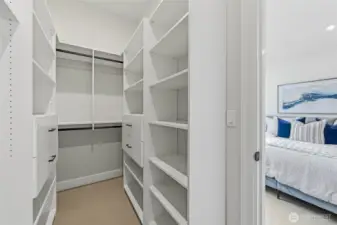 Primary closet with upscale built ins to make your closet life more organized.