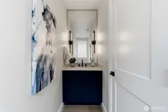 Downstairs powder room discreetly tucked out of site