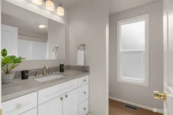 This full bathroom is located in the hallway and complements the three bedrooms & guests.