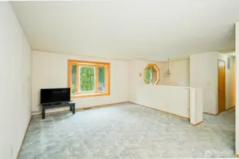 Living room on the upper level with a beautiful and decorative bay window.