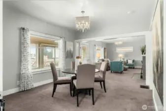 Cross section shot of front entry, dining and living rooms.