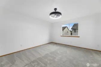 Primary Suite with new carpet and light fixture/fan.