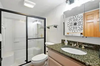 Bathroom has been updated with tile flooring with in floor heat, great shower with seat and lovely granite vanity.