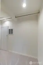 Such a large area to hang your clothes.  Through the door is the furnace access.
