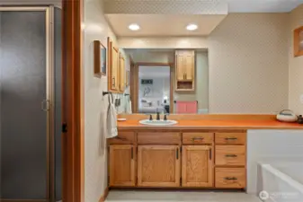 Large and lovely primary  en-suite. Solid wood cabinets. separate tub an shower.