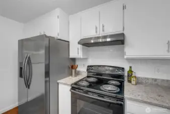 Newer side by side refrigerator freezer with ice and water dispenser.