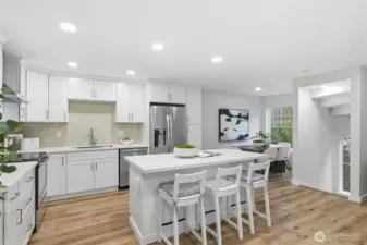 Open-concept main floor with oversized windows and seamless LVT flooring.