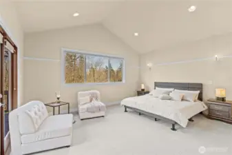 Primary suite with vaulted ceilings, ensuite 5 piece bath and walk in closet