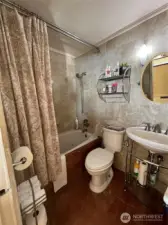 Upstairs bath has a jetted tub and marble floors.