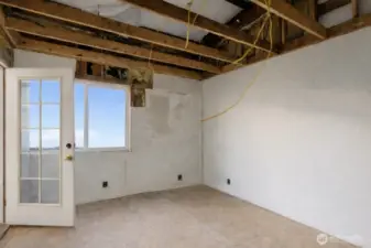 Unfinished second bedroom with outside access.