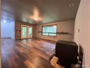 Lower level great room with wood stove and French doors