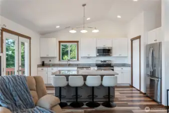 We love the layout here, with the great room concept. The living room and kitchen and eating areas blend seamlessly together.