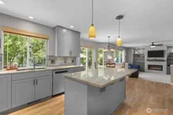 The kitchen and family room overlook a backdrop of lush greenery—bringing nature in and calm vibes all day long.