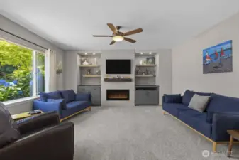 With modern built-ins and a striking linear gas fireplace, the family room blends clean design with effortless comfort.