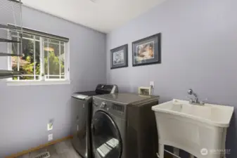 The main floor utility room is surprisingly spacious—plenty of room for laundry, storage, and everyday functionality.