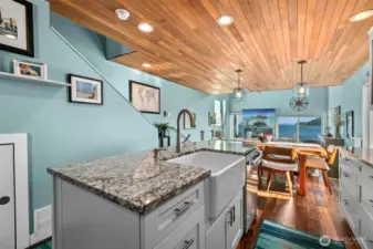 Look at the farmhouse sink and the beach wood color granite.