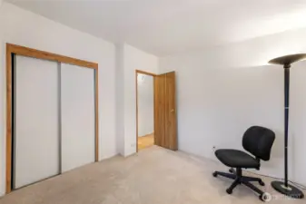 This secondary bedroom offers soft carpeting, neutral walls, and a large window—perfect for guests or home office needs near Lake Samish.
