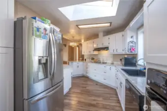 A full suite of sleek stainless-steel appliances adds contemporary elegance.