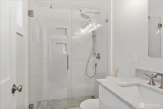 The recently updated primary bathroom features a walk-in shower.