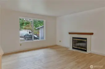 Open living room with fireplace.