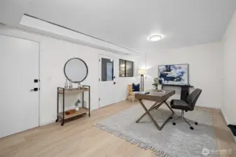This lower level bedroom is accessed from the rec room and lower bathroom, or from this door that leads to the covered patio area and garage. The floor is brand new, with fresh paint and new ceiling light. This room would make a great home office too.