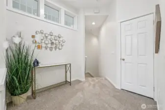 Main floor landing looking back to stairs, coat closet on right.