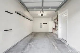 Large finished garage with entry door to home on the right