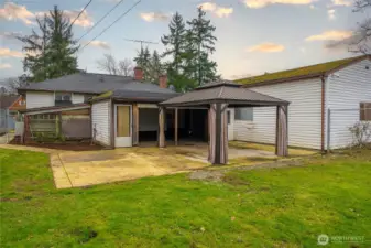 Back of the home - showing the patio and the huge garage on the right.