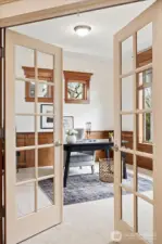 Just off the entry and through the beautiful French doors is the thoughtfully designed office with architectural details.