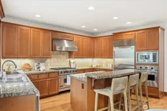 Epicurean kitchen boasts professional-grade stainless steel appliances: Viking 6-burner cooktop, double oven, Sub-Zero refrigerator, Miele dishwasher, and brand-new Viking microwave.