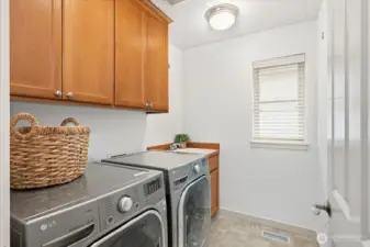 Added convenience: Upstairs laundry room with utility sink makes doing laundry easy & efficient.