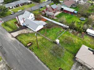 You can see there's alot more yard in the back here and to the side as well. 3 raised garden beds and 2 fruit trees. A cherry & a 100 year old apple tree that produces delicious red apples.