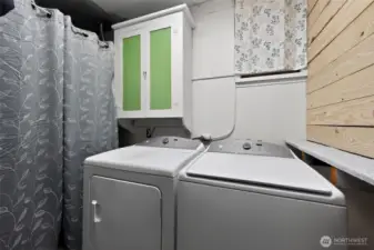 Utility room with washer and dryer that stay.
