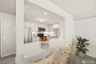 Bright, functional layout with breakfast bar & under-cabinet lighting. (Virtually Staged)
