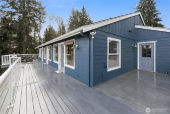 Large composite deck for easy maintenance. The door to the right is access to the 2 car garage.