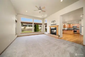 Large living room on the main w/ so much natural light &  see-through gas fireplace