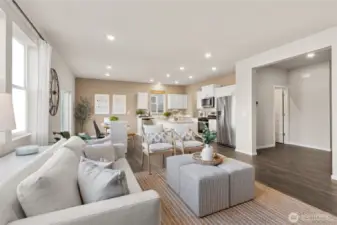Living Room, Dining and Kitchen. Photos are of model home of the same plan and may reflect different colors and options.