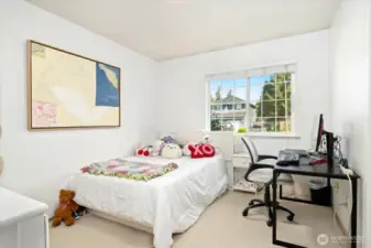 Large bright bedroom with space for dresser, desk and bed.