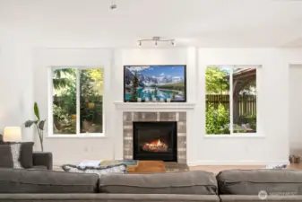 Large living room with vaulted ceilings and gas fireplace adjacent to the dining area and steps from your backyard deck and hot tub for total relaxation.